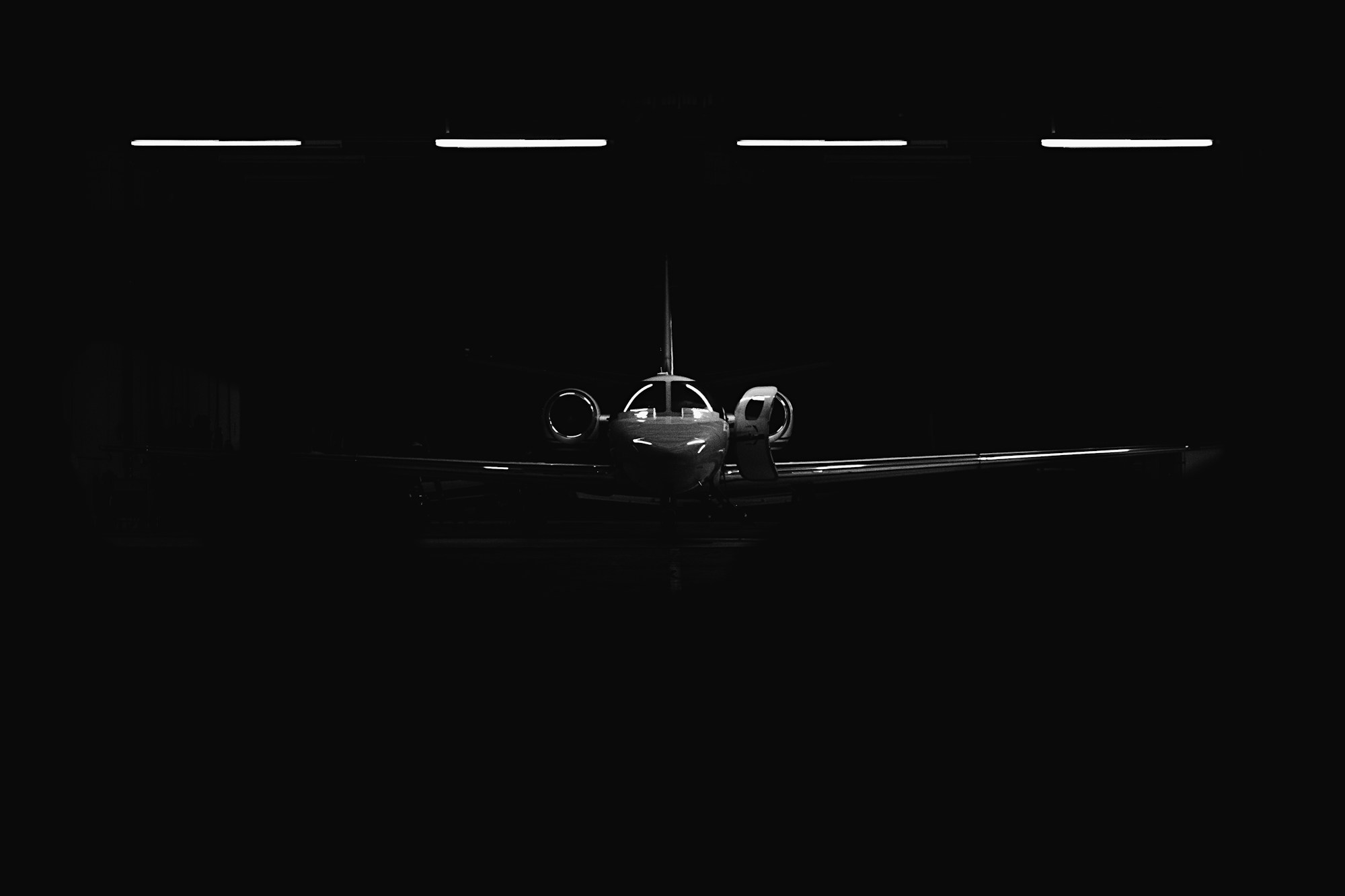 Private jet in a dark aircraft hangar